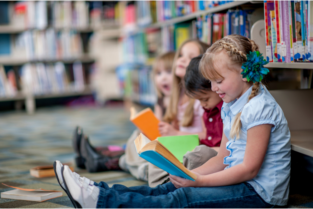 Kids reading books in a library.