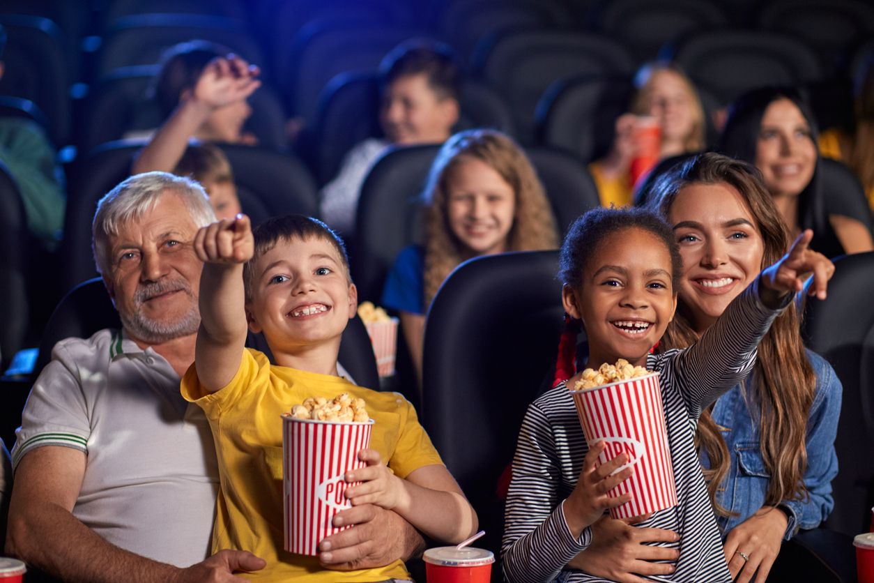Kids at the cinema with parents.