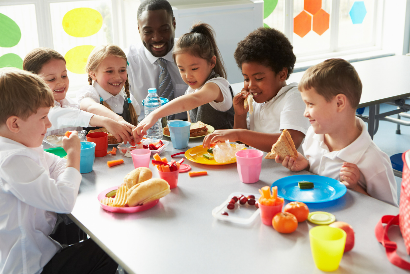 Children eating around a table.