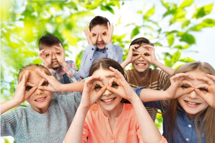 Children with hands over their eyes and watching through a circle.