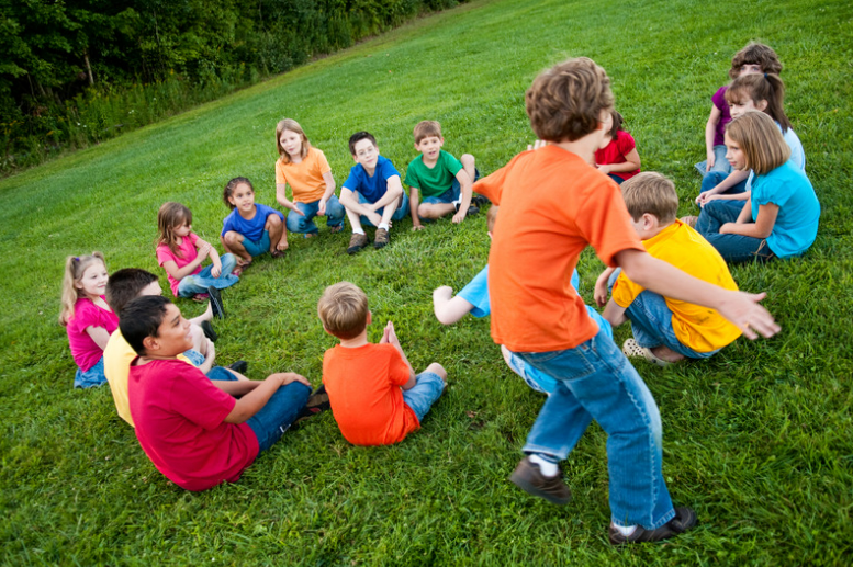 Kids playing duck duck goose.